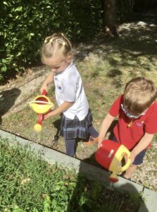 children watering a garden